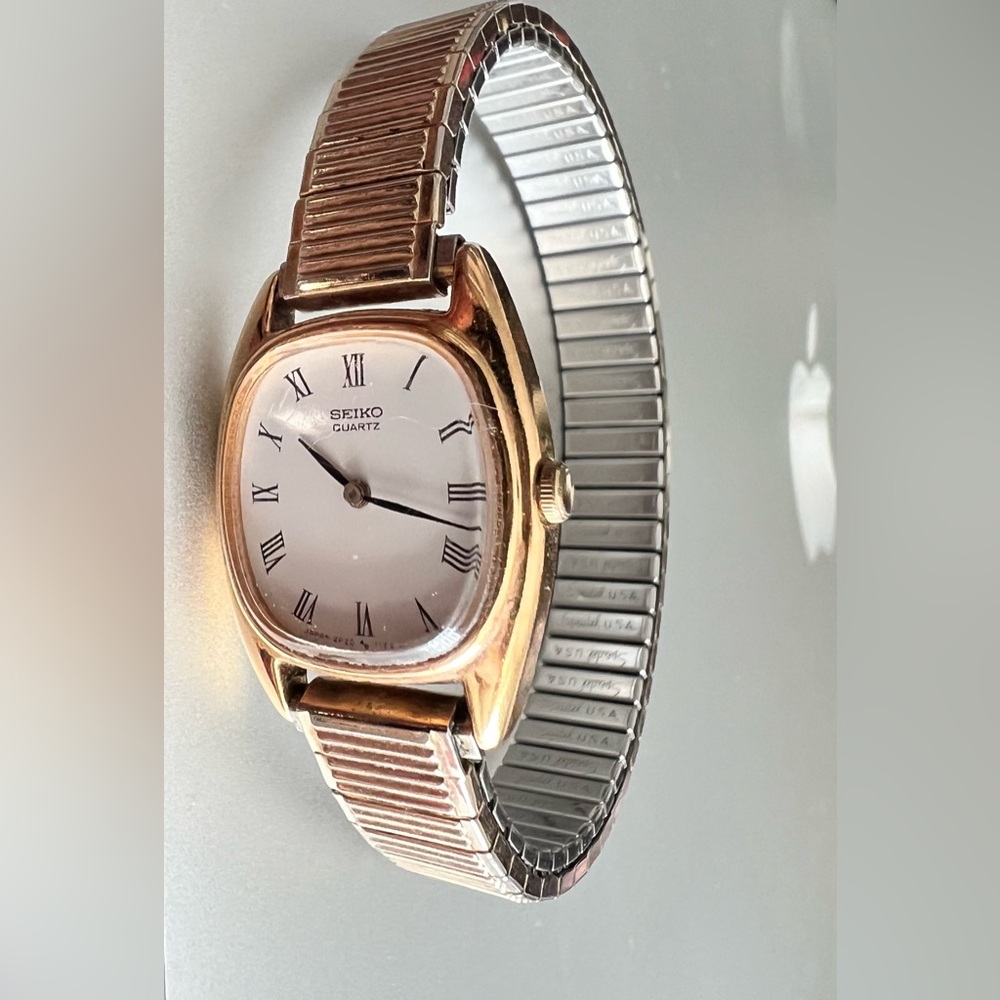 Seiko Quartz, Gold and White Tone metal with Elastic Band and Roman Numerals.